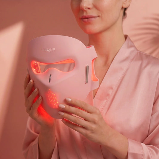 Longera AVA LED face and neck mask with red light held in woman's hands