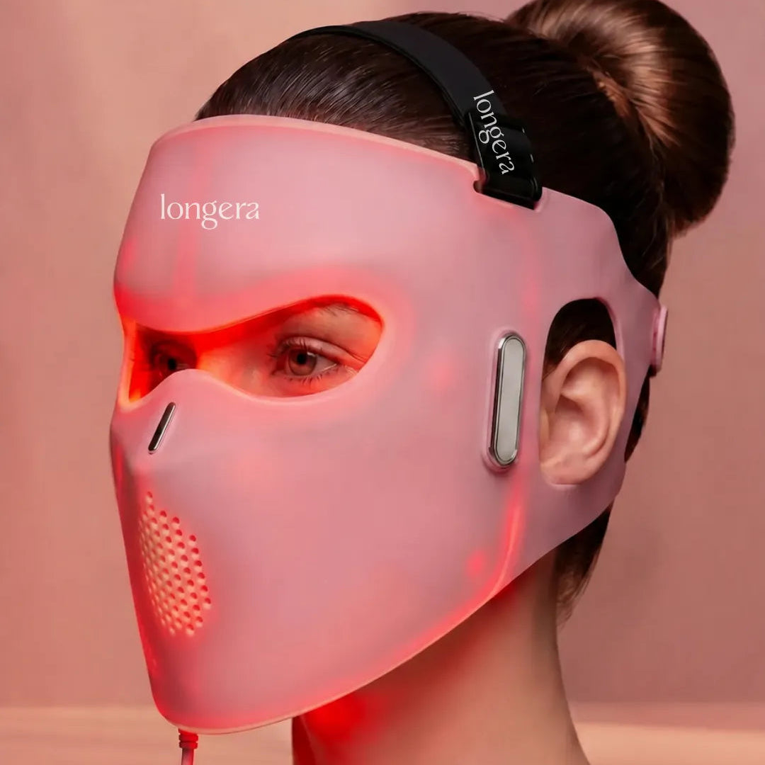Woman wearing the Longera AVA LED face and neck mask emitting red light during an at-home skincare routine